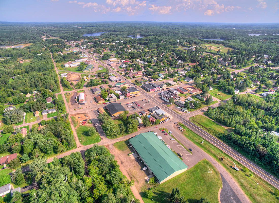 Gays Mills, WI - Aerial View of a Town With Many Green Trees Around Town on a Sunny Day